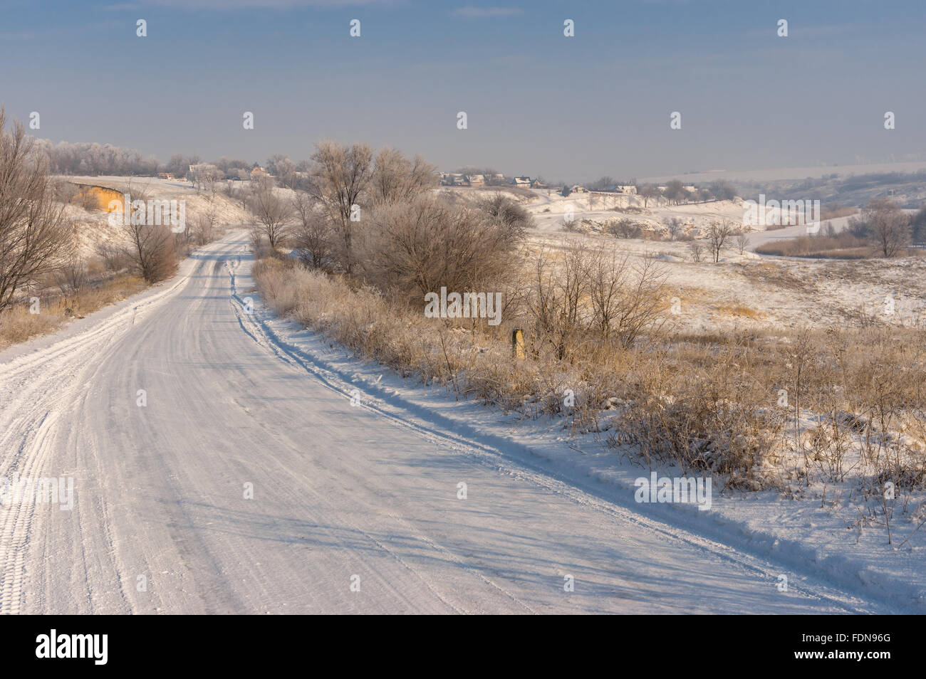 Winter landscape with country road leading to Novo-Nikolaevka village in Dnepropetrovskaya oblast, Ukraine Stock Photo