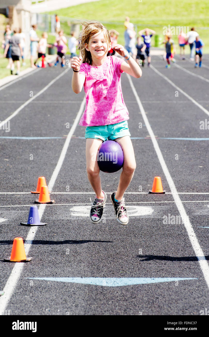 Girl playing ball games on track and field day Stock Photo Alamy