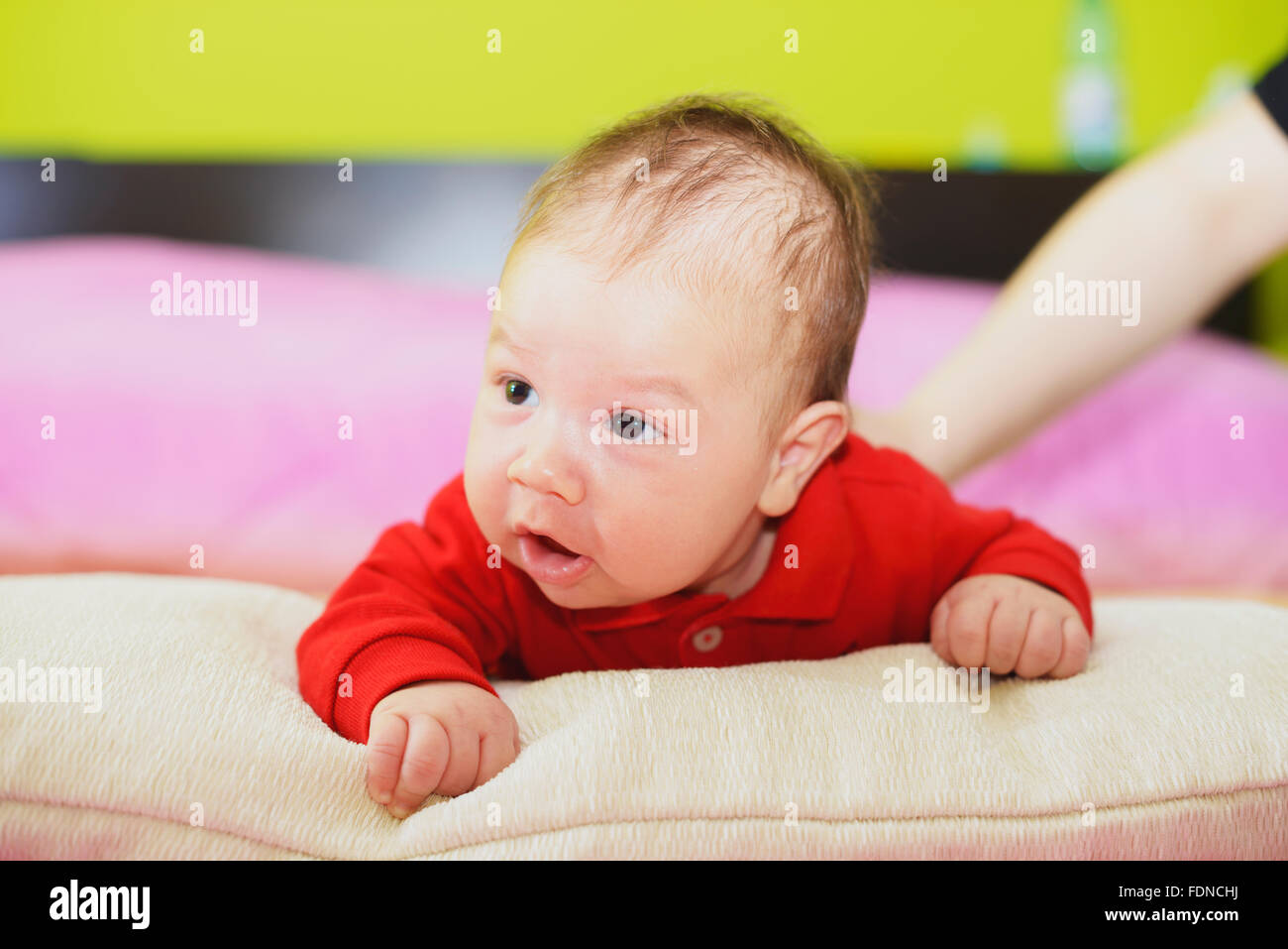 newborn baby lying on his stomach and looking forward Stock Photo Alamy