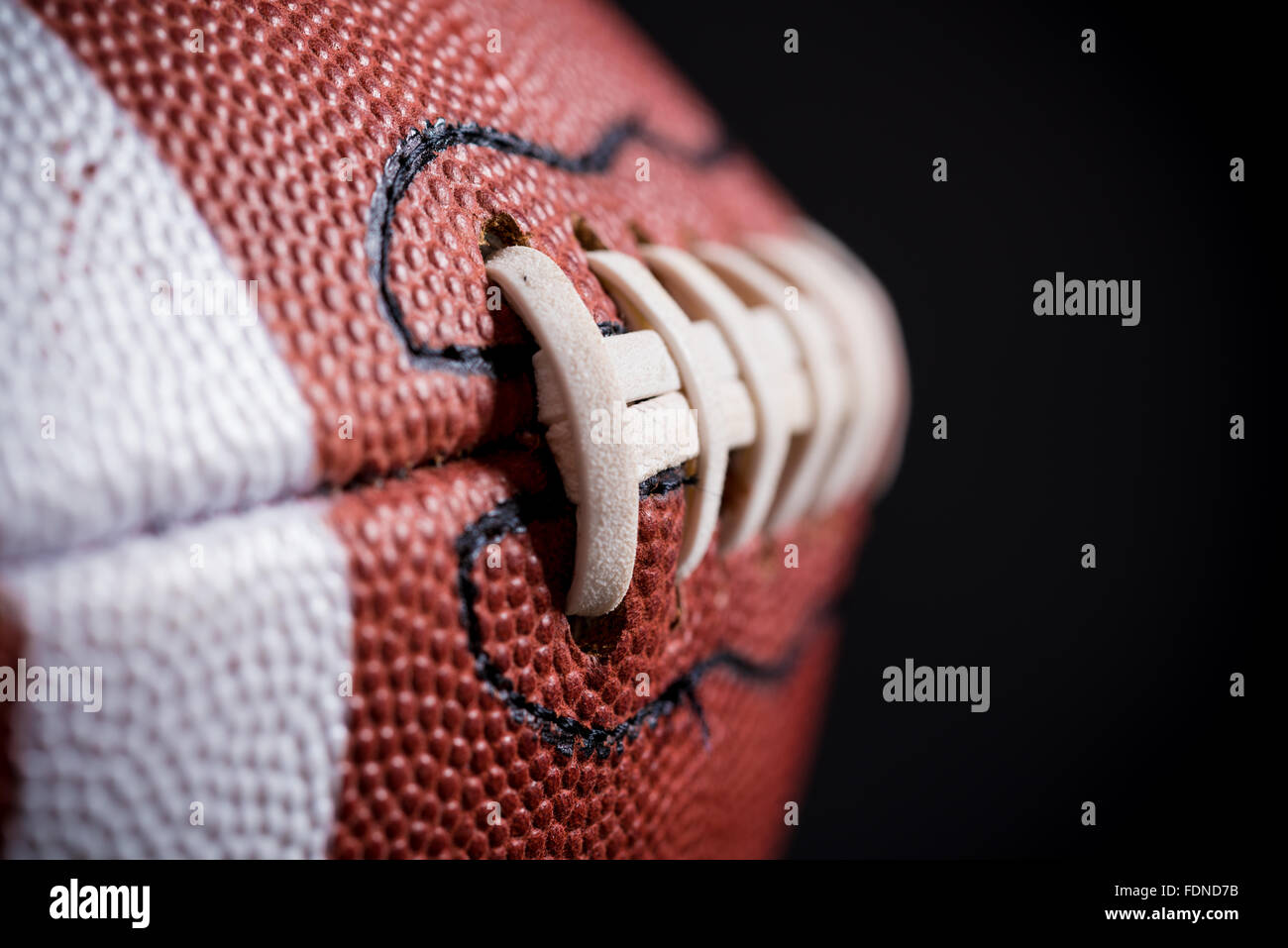 A leather American football on black background Stock Photo Alamy
