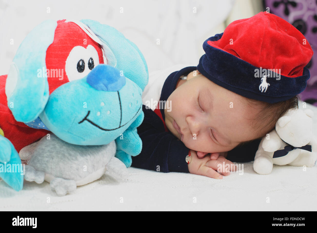 newborn baby boy sleeping with his toys Stock Photo Alamy