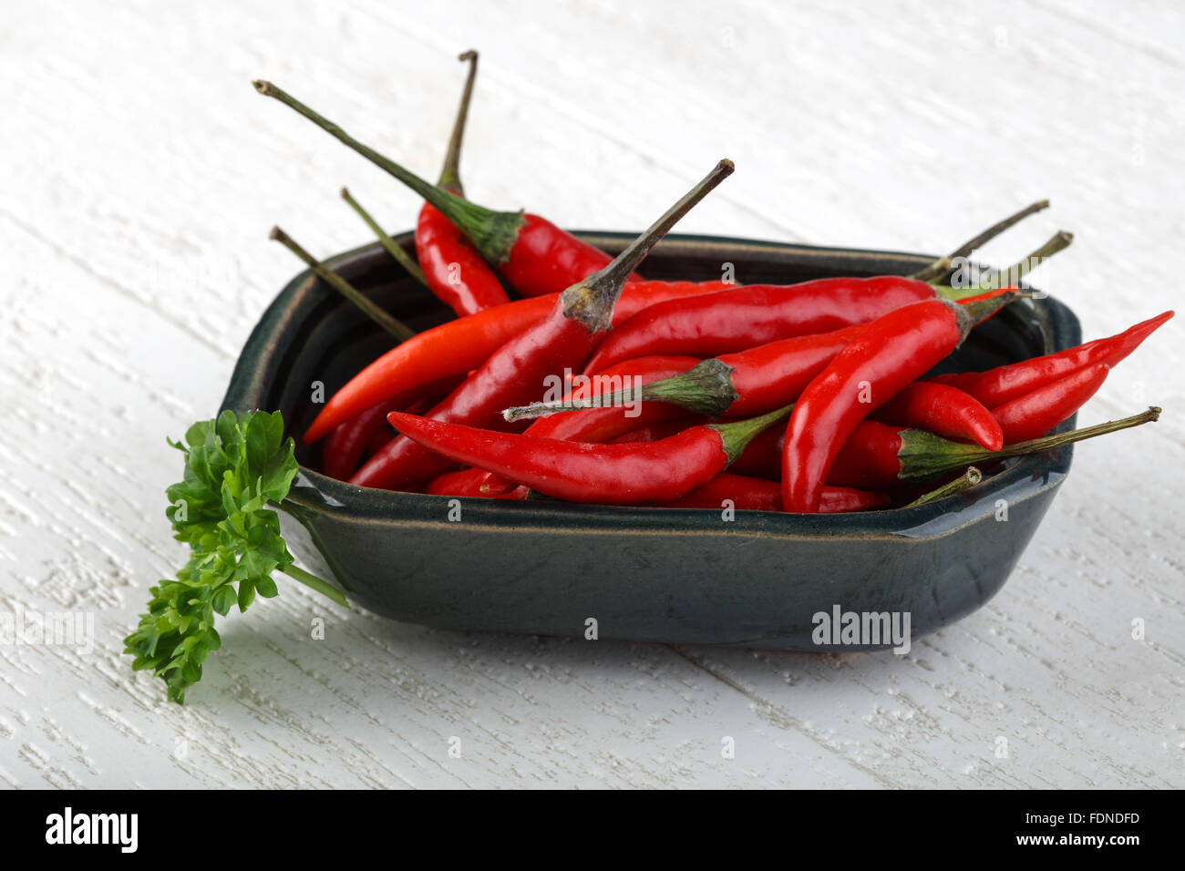 Red hot chili peppers heap on the wood background Stock Photo - Alamy