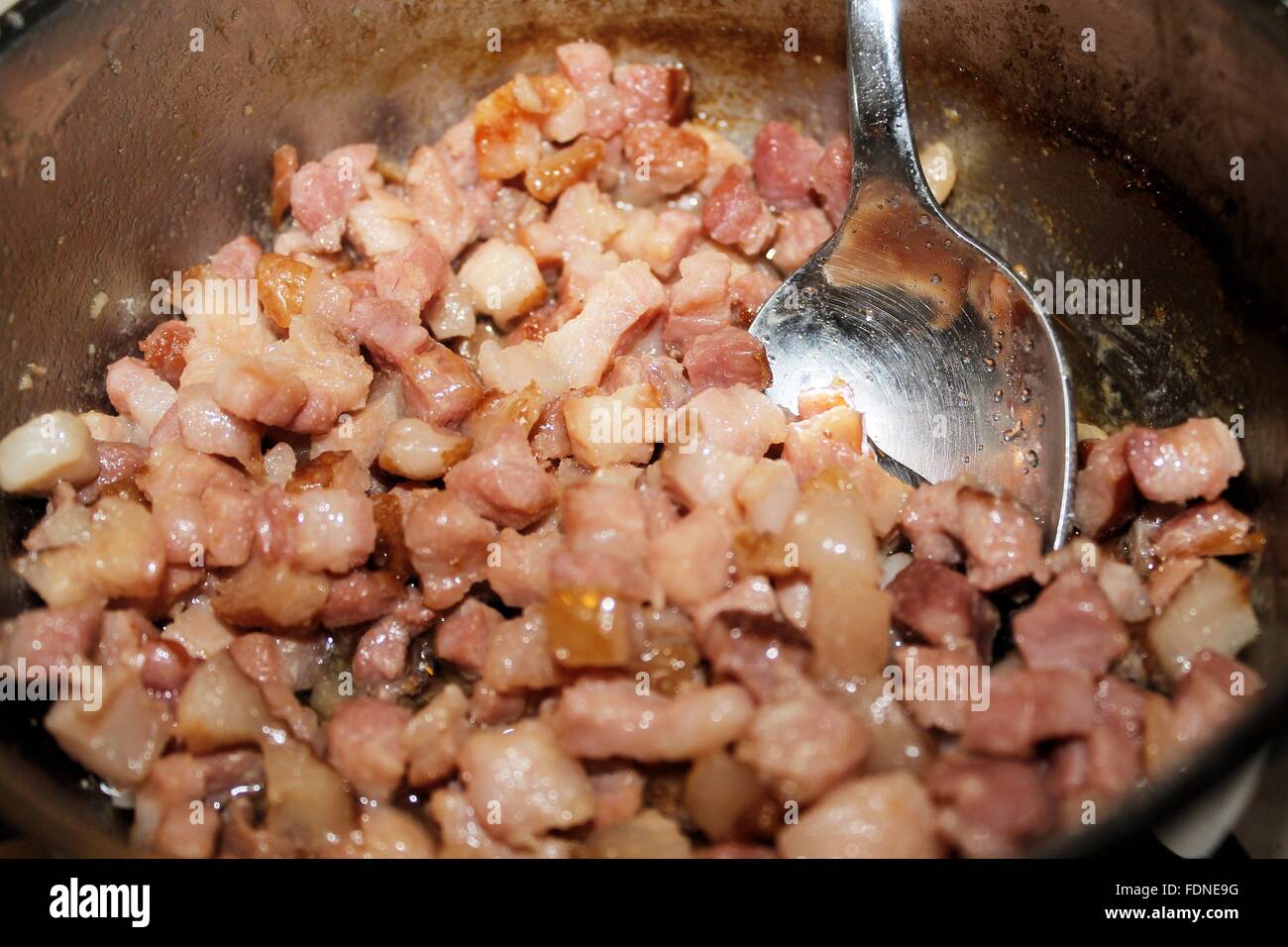 diced bacon frying in a pan with oil Stock Photo Alamy