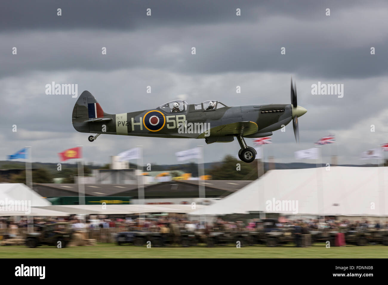 Spitfire skimming the marquees at Goodwood Revival Stock Photo