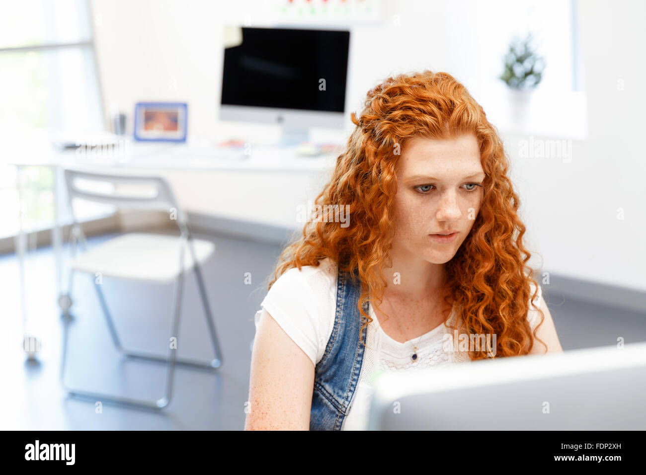 Young and pretty business woman working in office Stock Photo - Alamy
