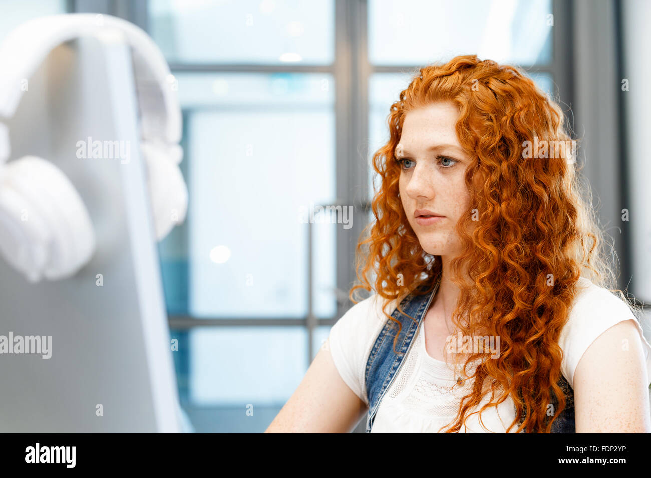 Young and pretty business woman working in office Stock Photo - Alamy
