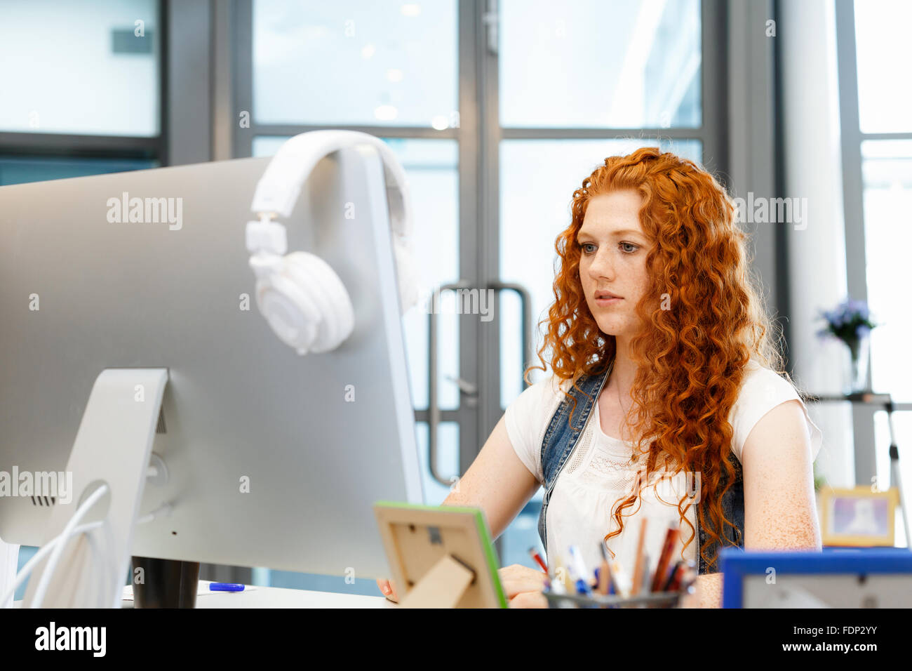 Young and pretty business woman working in office Stock Photo - Alamy
