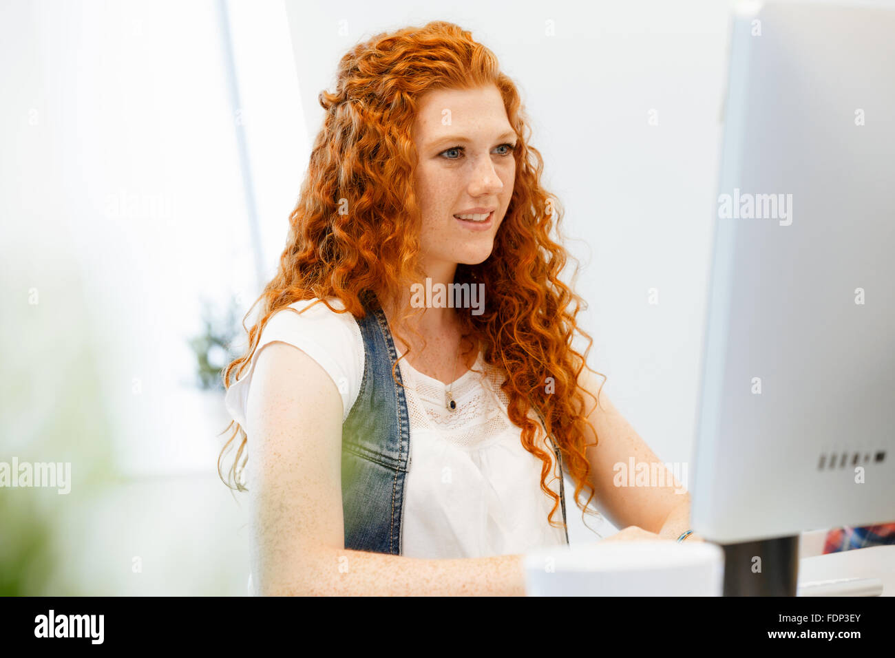 Young and pretty business woman working in office Stock Photo - Alamy