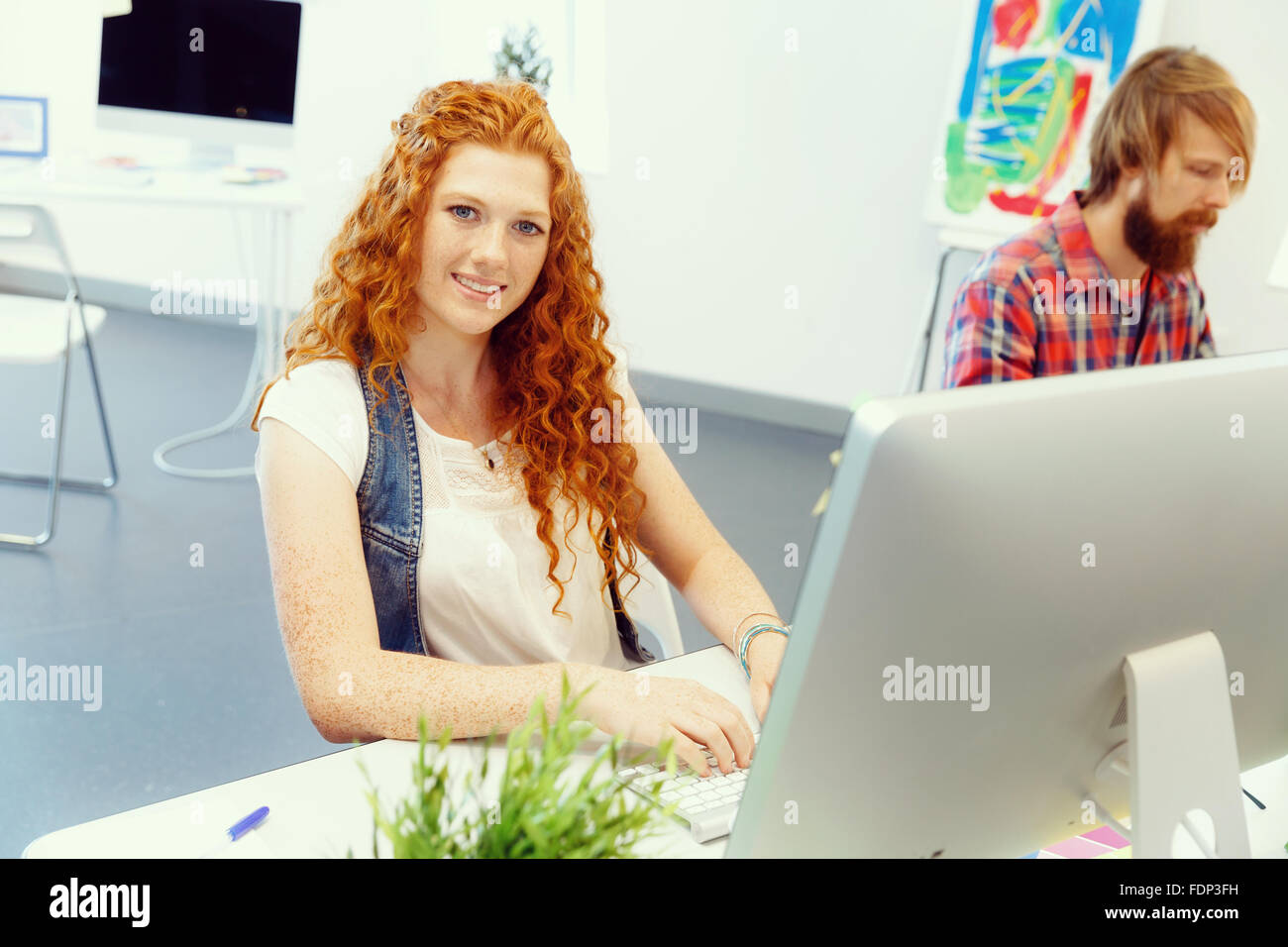 Young and pretty business woman working in office Stock Photo - Alamy