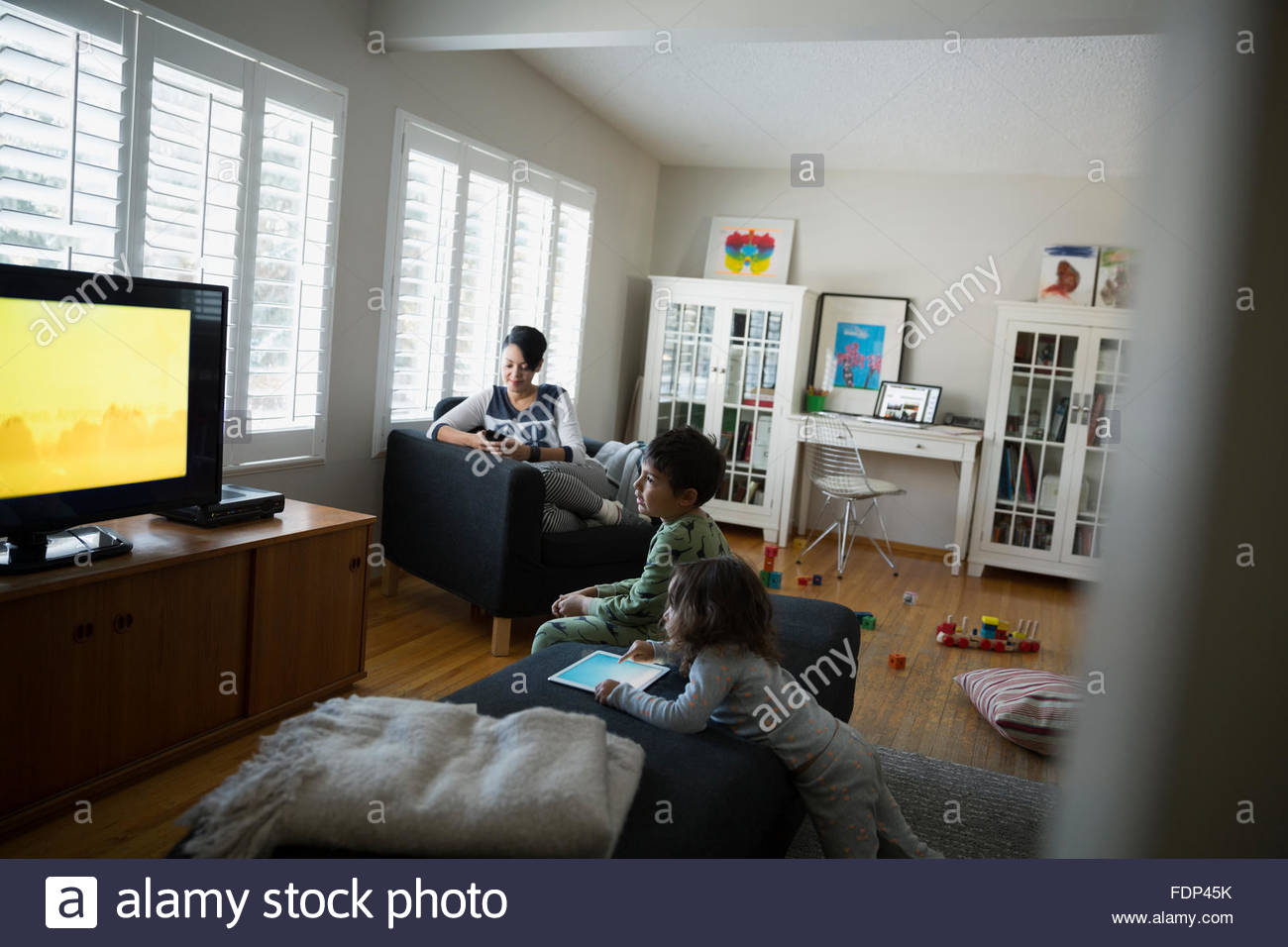 Family relaxing watching TV in living room Stock Photo