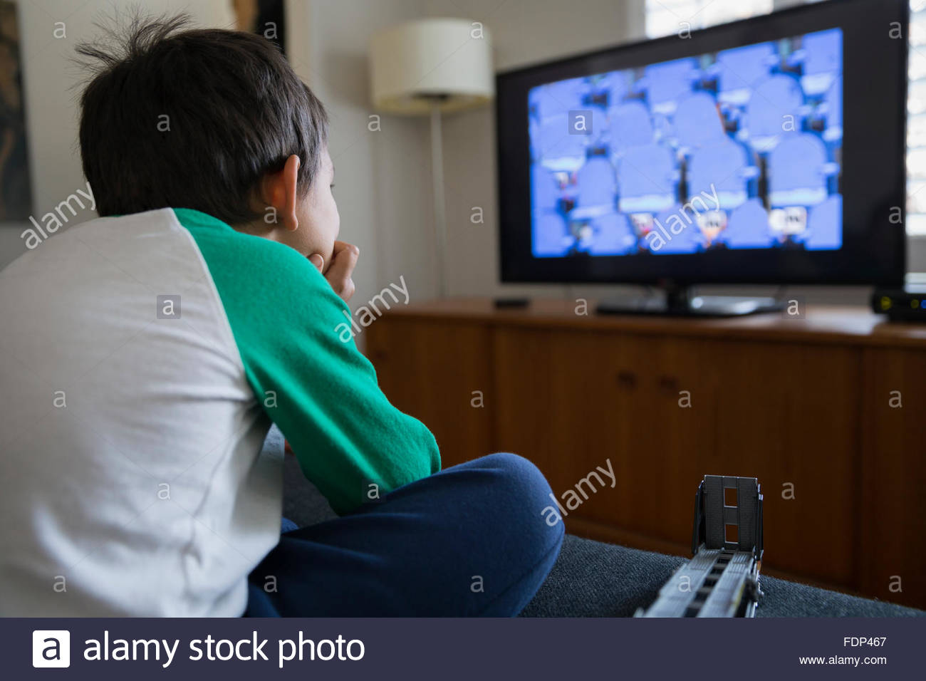 Boy watching TV in living room Stock Photo