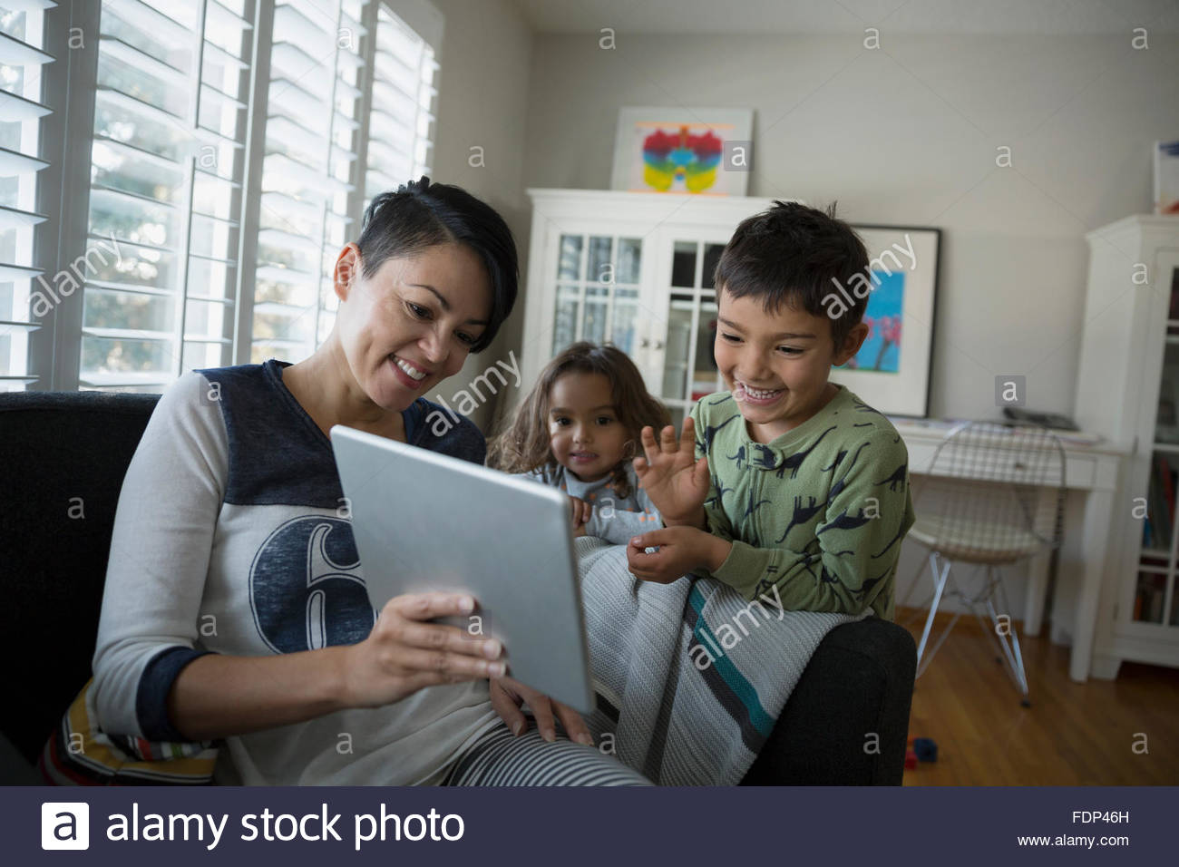 Family video chatting on digital tablet living room Stock Photo