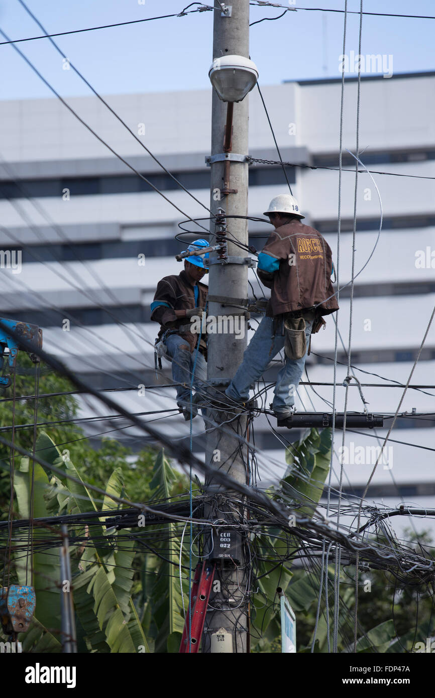 Cebu City,Philippines,Electricity Company employees working on overhead power lines. Stock Photo
