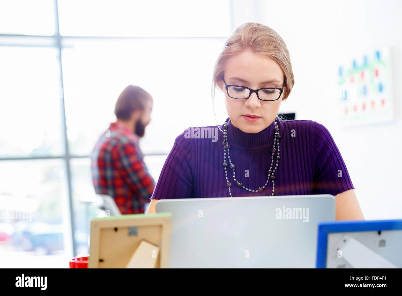 Young and pretty business woman working in office Stock Photo - Alamy