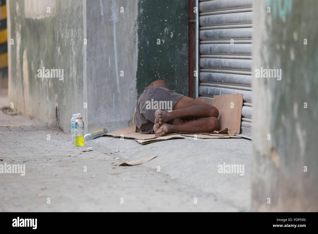 Homeless Person sleeping in a side street,Downtown Cebu City,Philippines Stock Photo