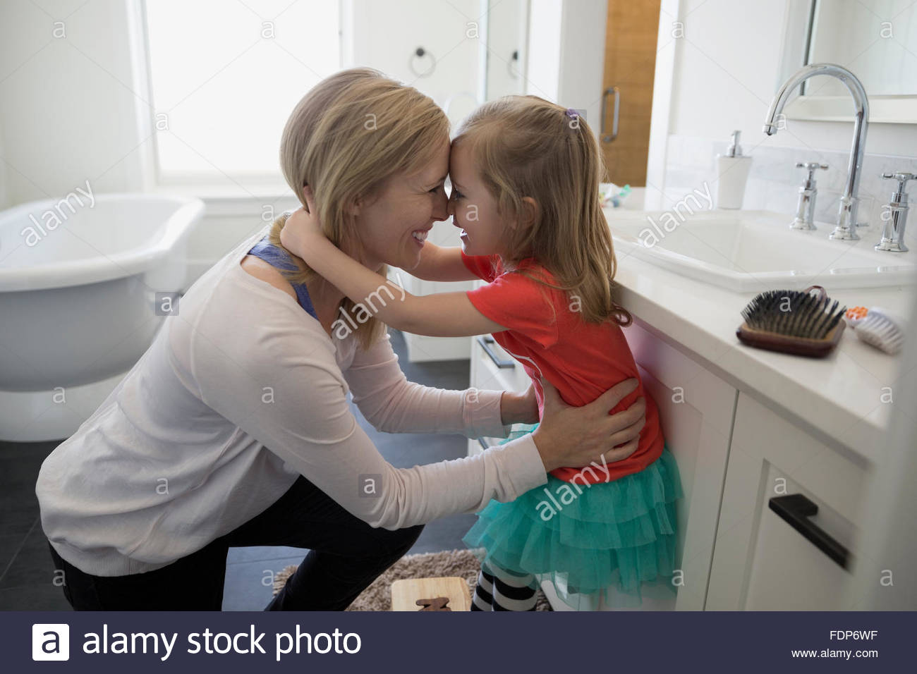 Affectionate mother and daughter rubbing noses in bathroom Stock Photo Alamy
