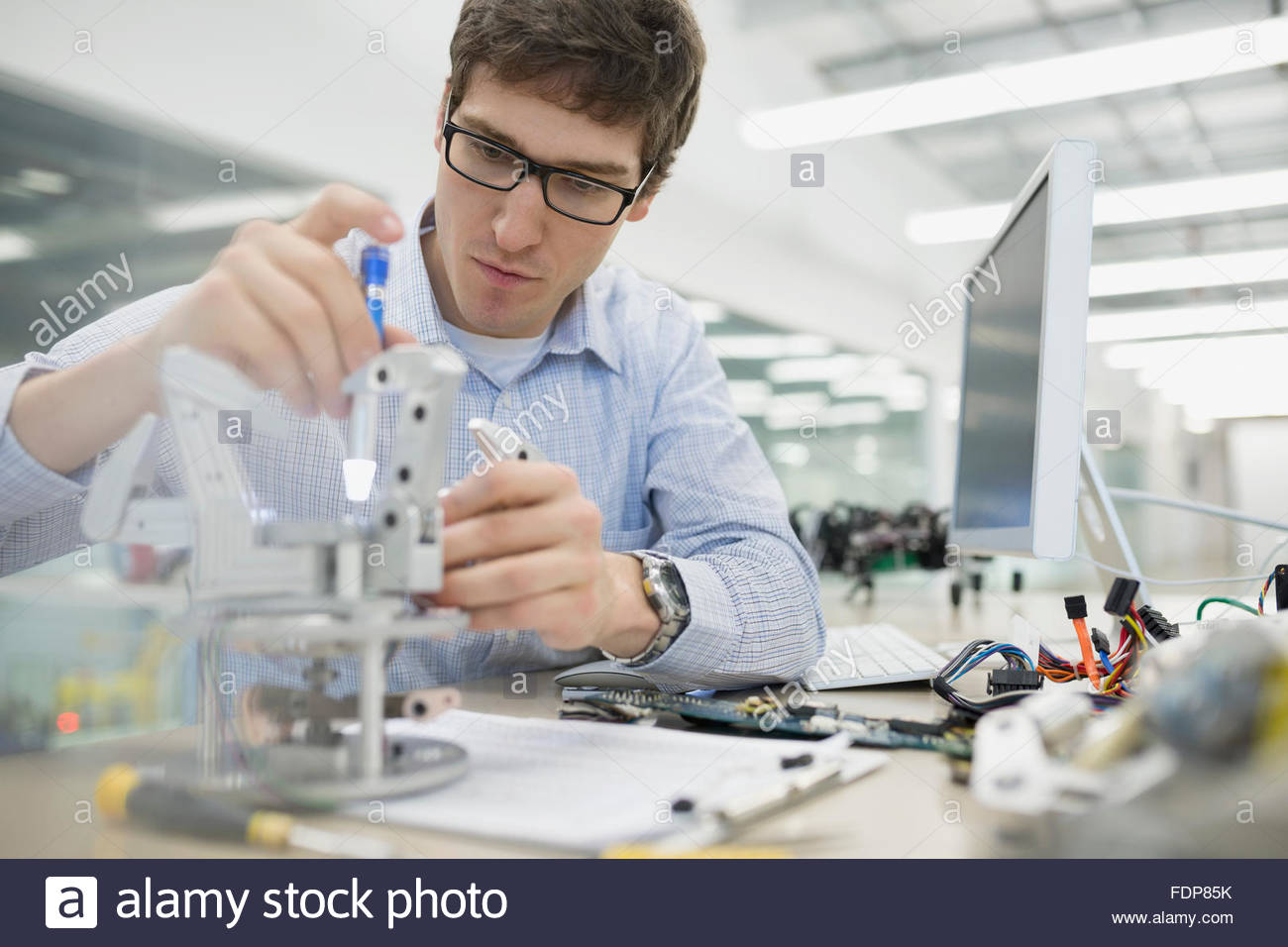 Focused engineer assembling robotics Stock Photo