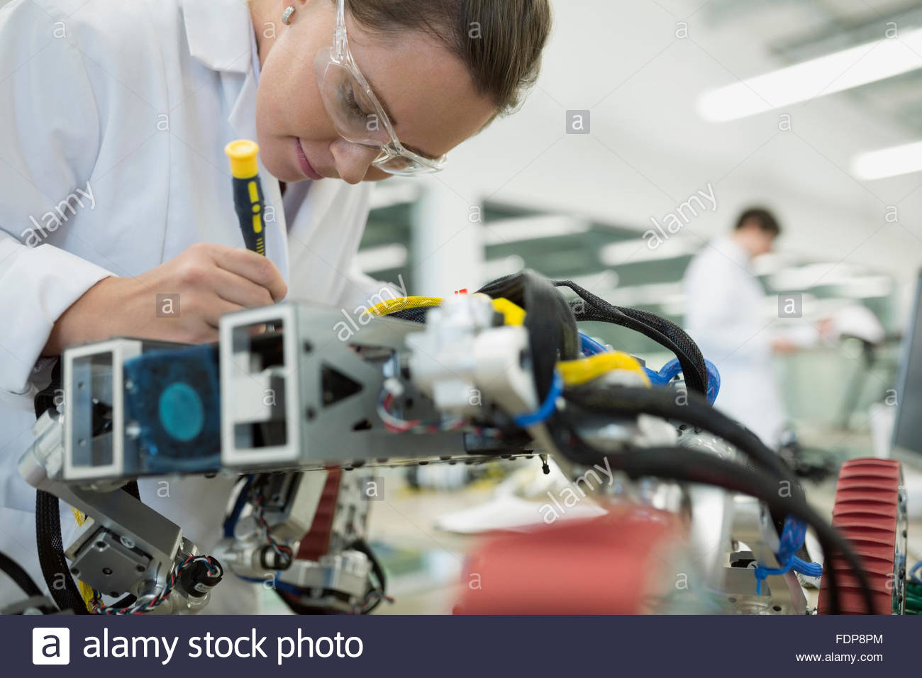 Engineer assembling robotics in factory Stock Photo
