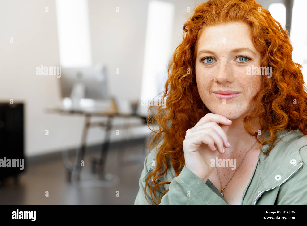 Young and pretty business woman in office Stock Photo - Alamy