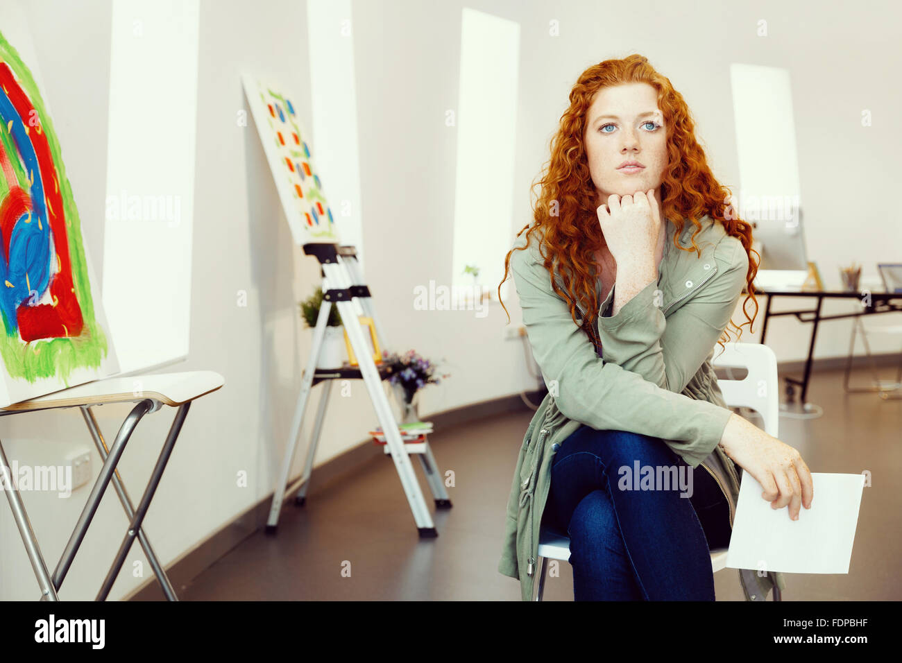 Young female artist in gallery with her picture Stock Photo - Alamy