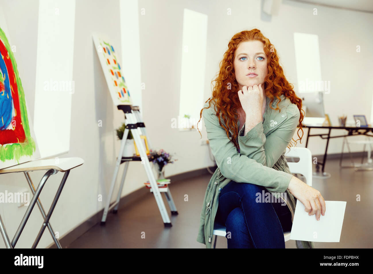 Young female artist in gallery with her picture Stock Photo - Alamy