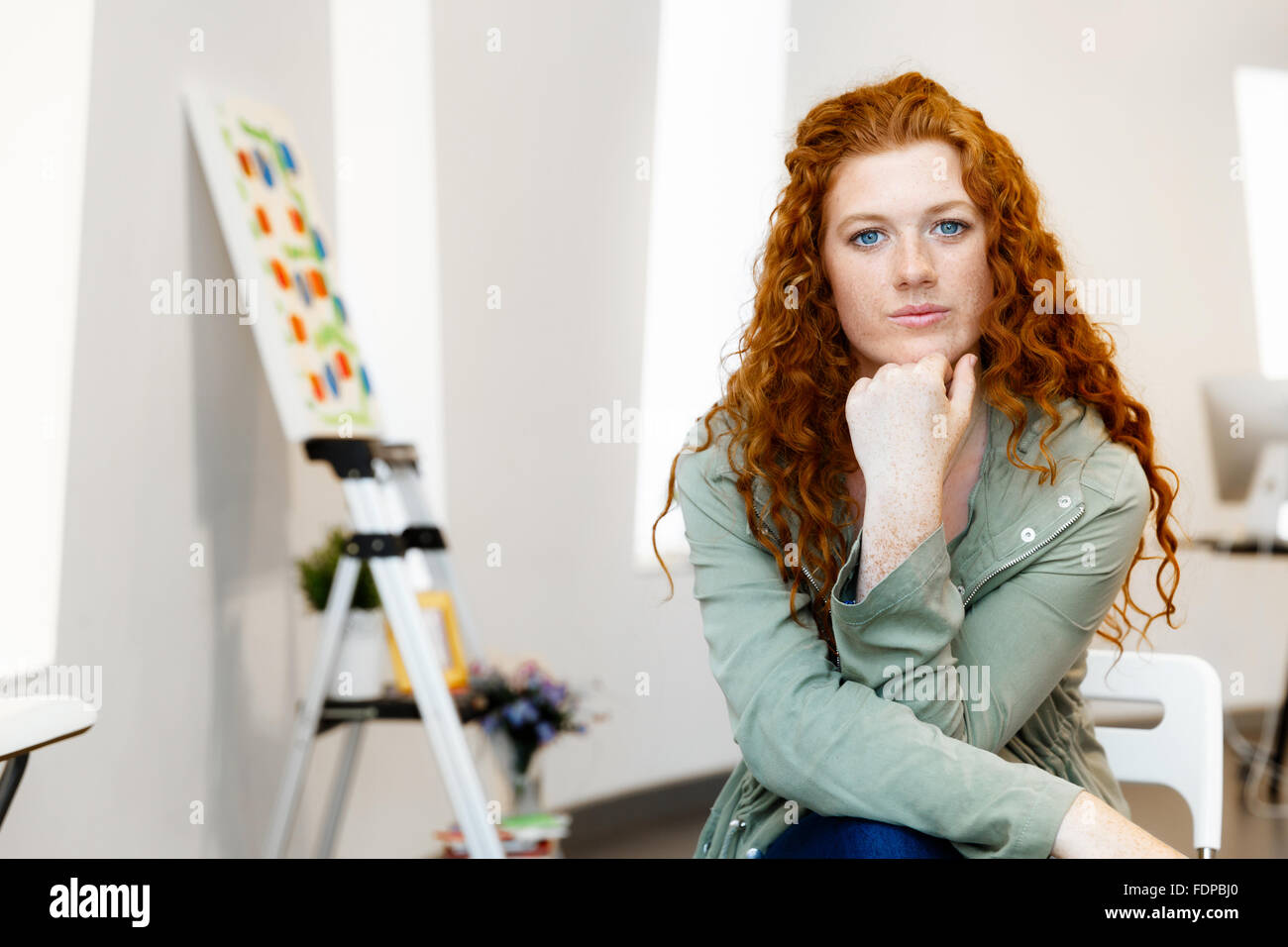 Young female artist in gallery with her picture Stock Photo - Alamy