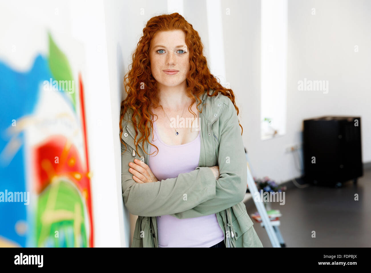 Young female artist in gallery with her picture Stock Photo - Alamy