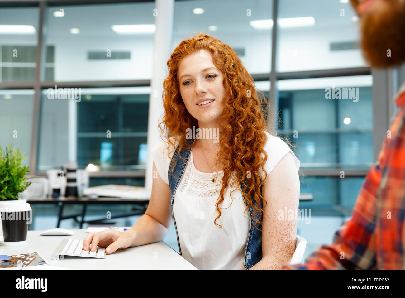 Young and pretty business woman working in office Stock Photo - Alamy