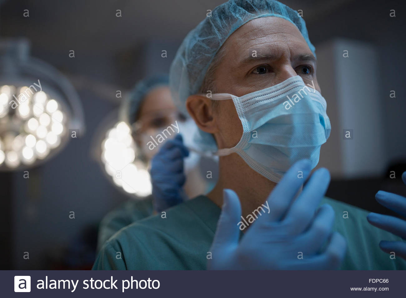 Surgeon in protective workwear looking away Stock Photo
