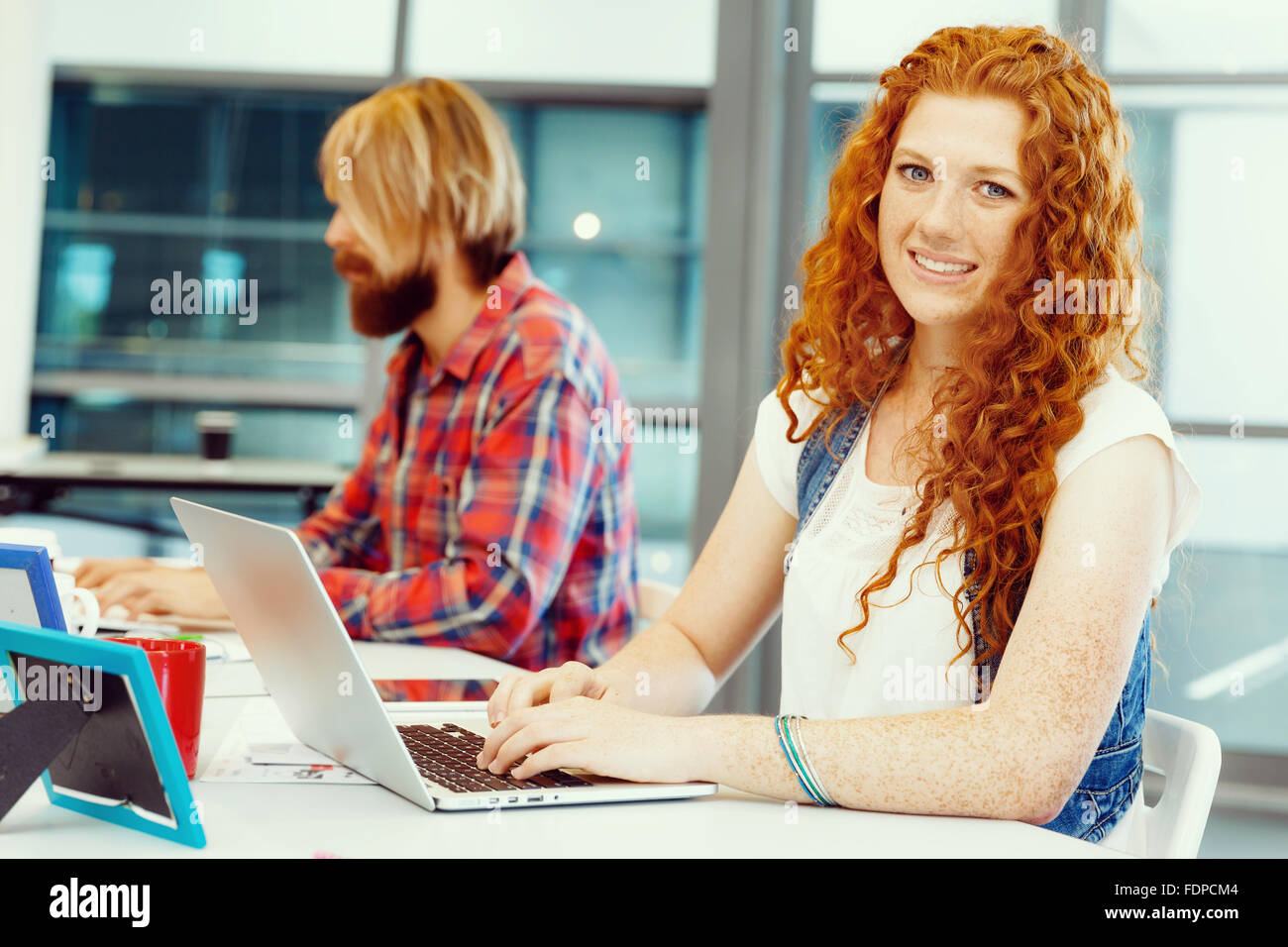 Young and pretty business woman working in office Stock Photo - Alamy