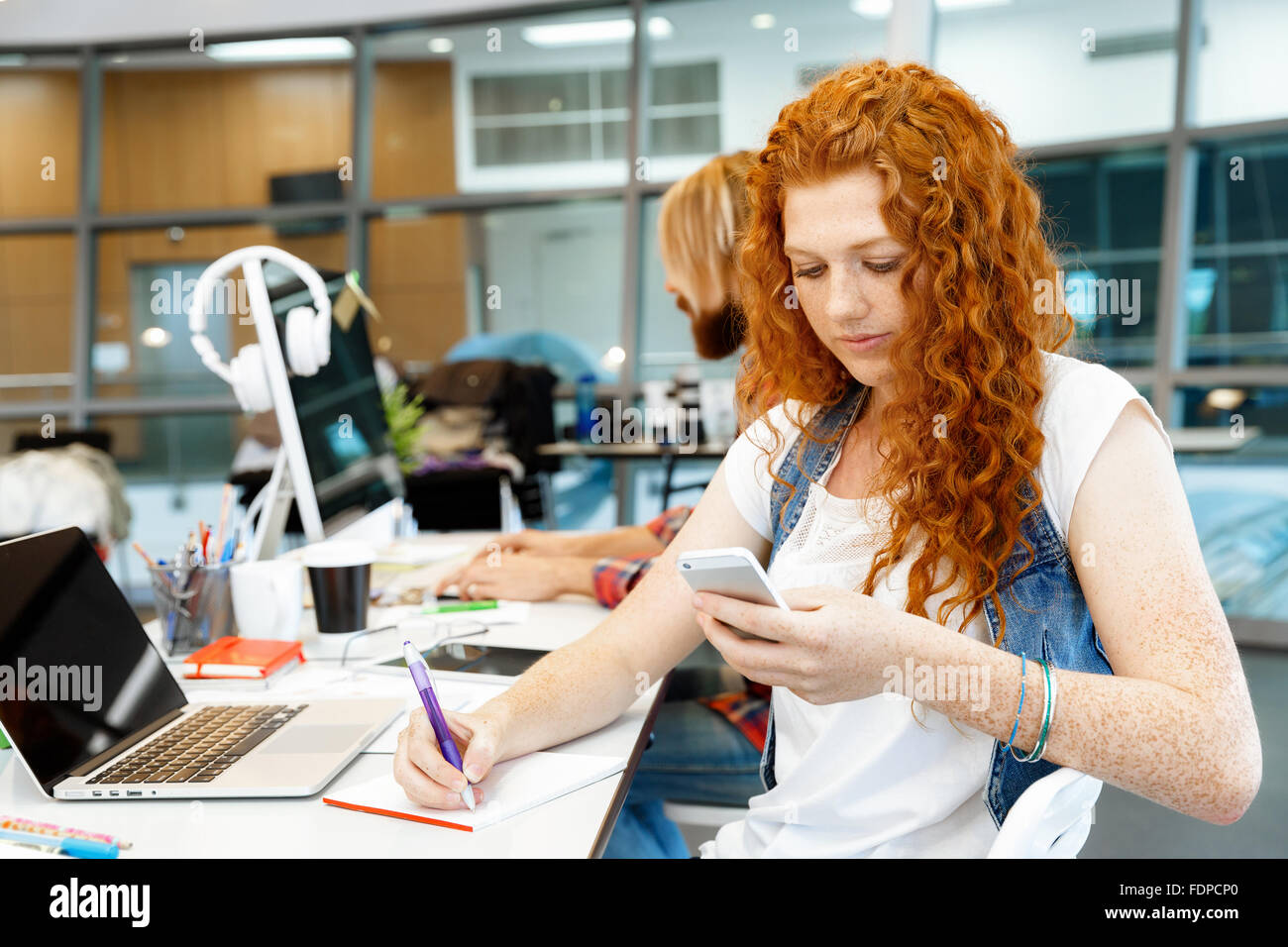 Young and pretty business woman working in office Stock Photo - Alamy