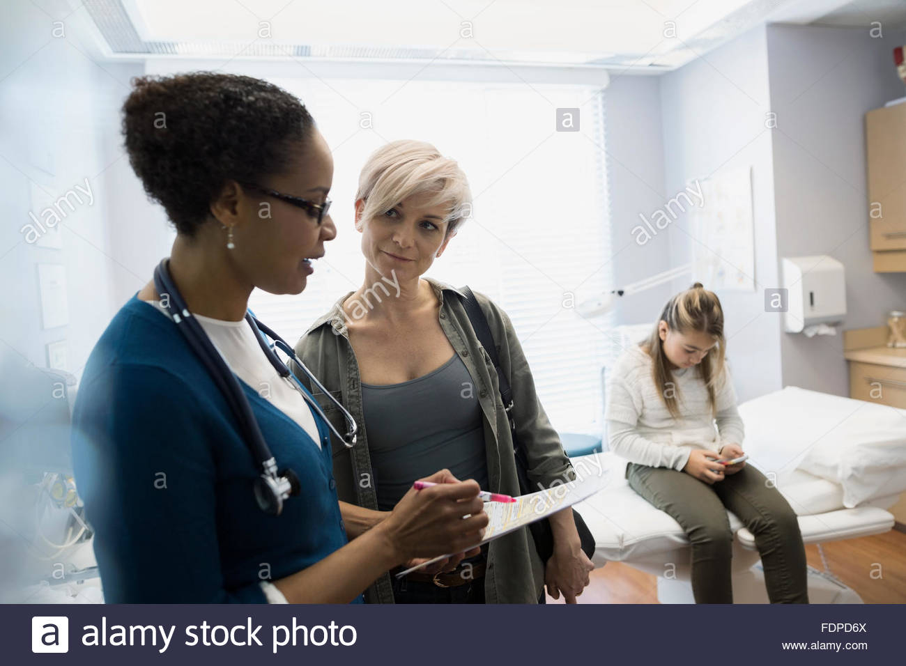 Pediatrician discussing results with mother Stock Photo