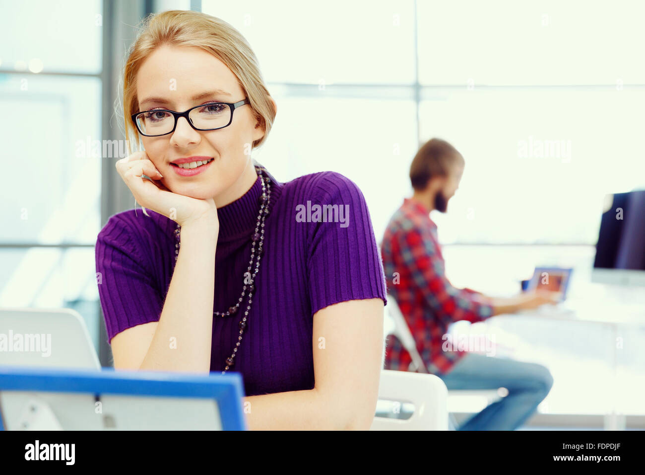 Young and pretty business woman working in office Stock Photo - Alamy