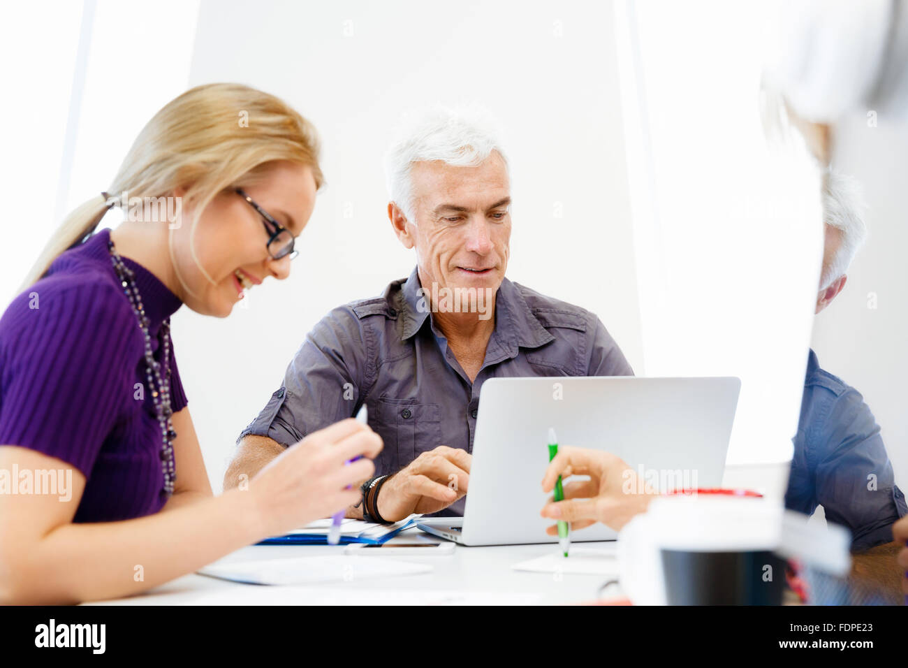 Business team working together in office Stock Photo - Alamy