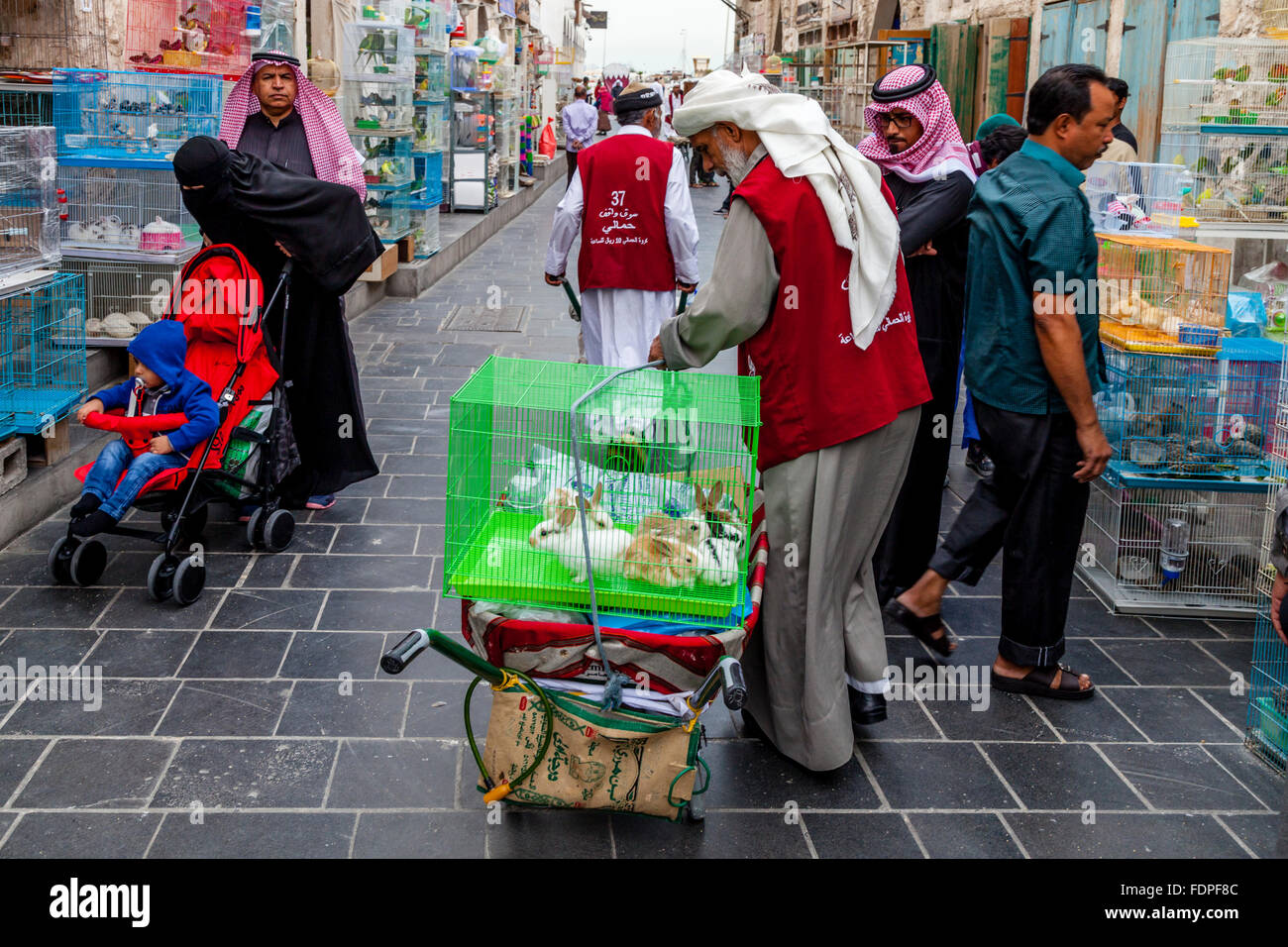 A Market Porter Prepares To Transport Caged Pets For A Customer, Souk