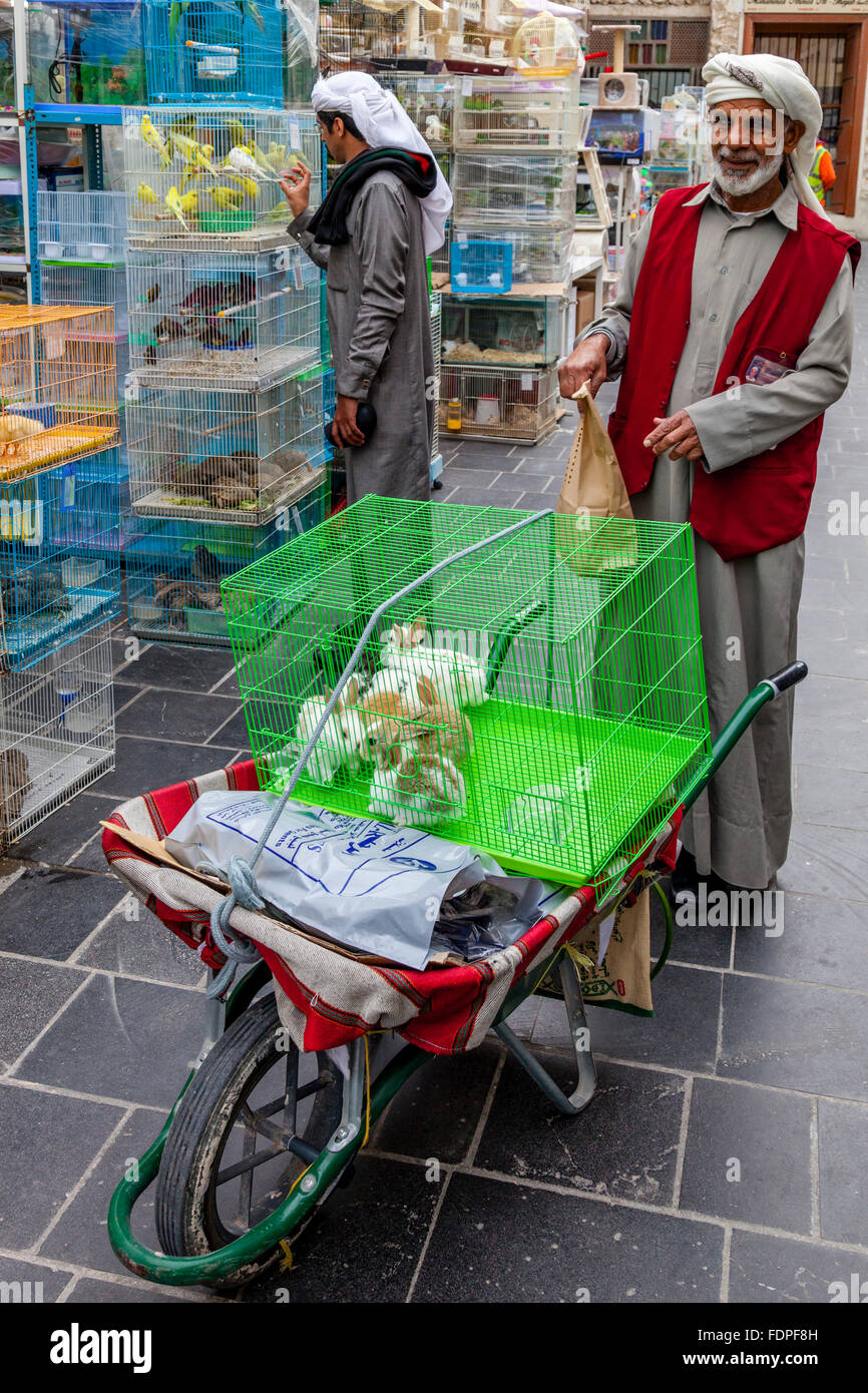 A Market Porter Prepares To Transport Caged Pets For A Customer, Souk