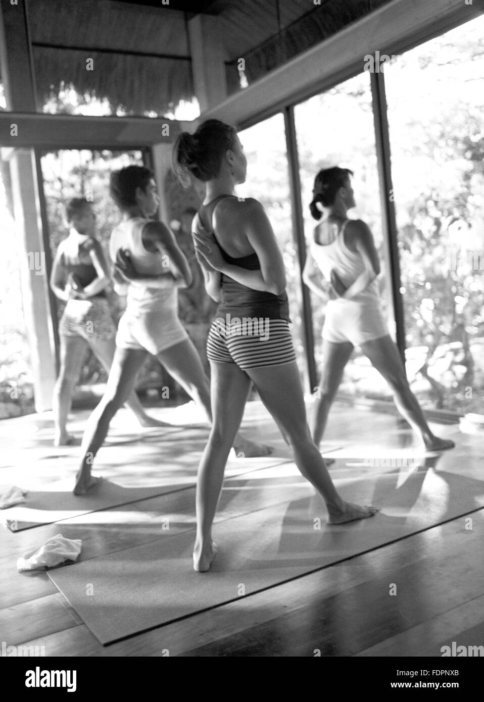 Ashtanga yoga instrucyor Mo-Ching Yip leads students in Pyramid Pose or Parshvottanasana. Mandala Spa, Boracay Island, Philippin Stock Photo