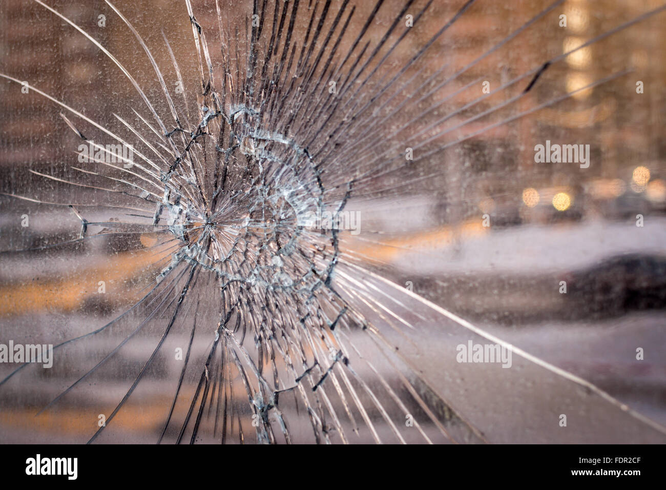 Cracked broken glass background with a city tower block backdrop, great