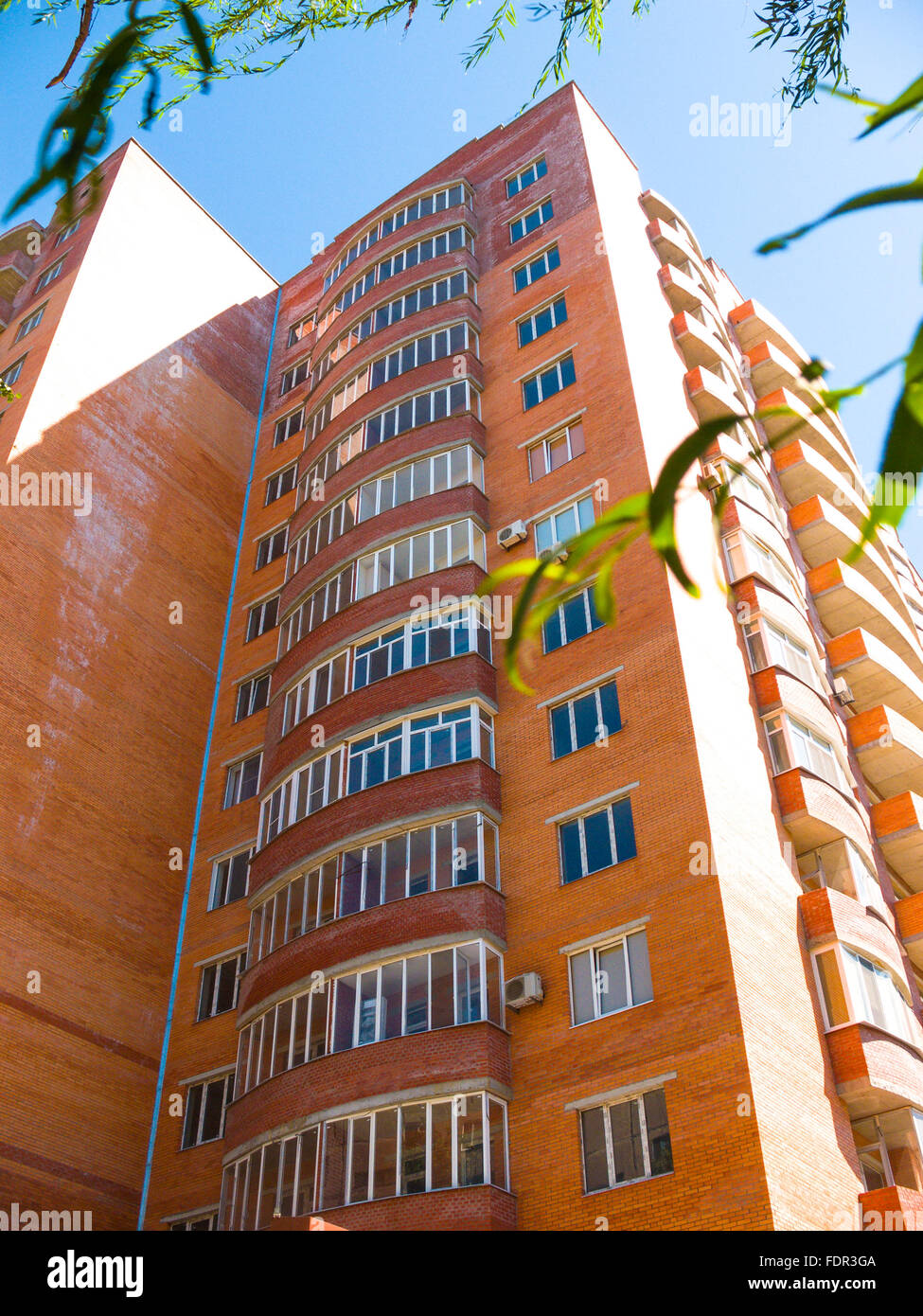 high residential house on blue sky background with trees Stock Photo ...