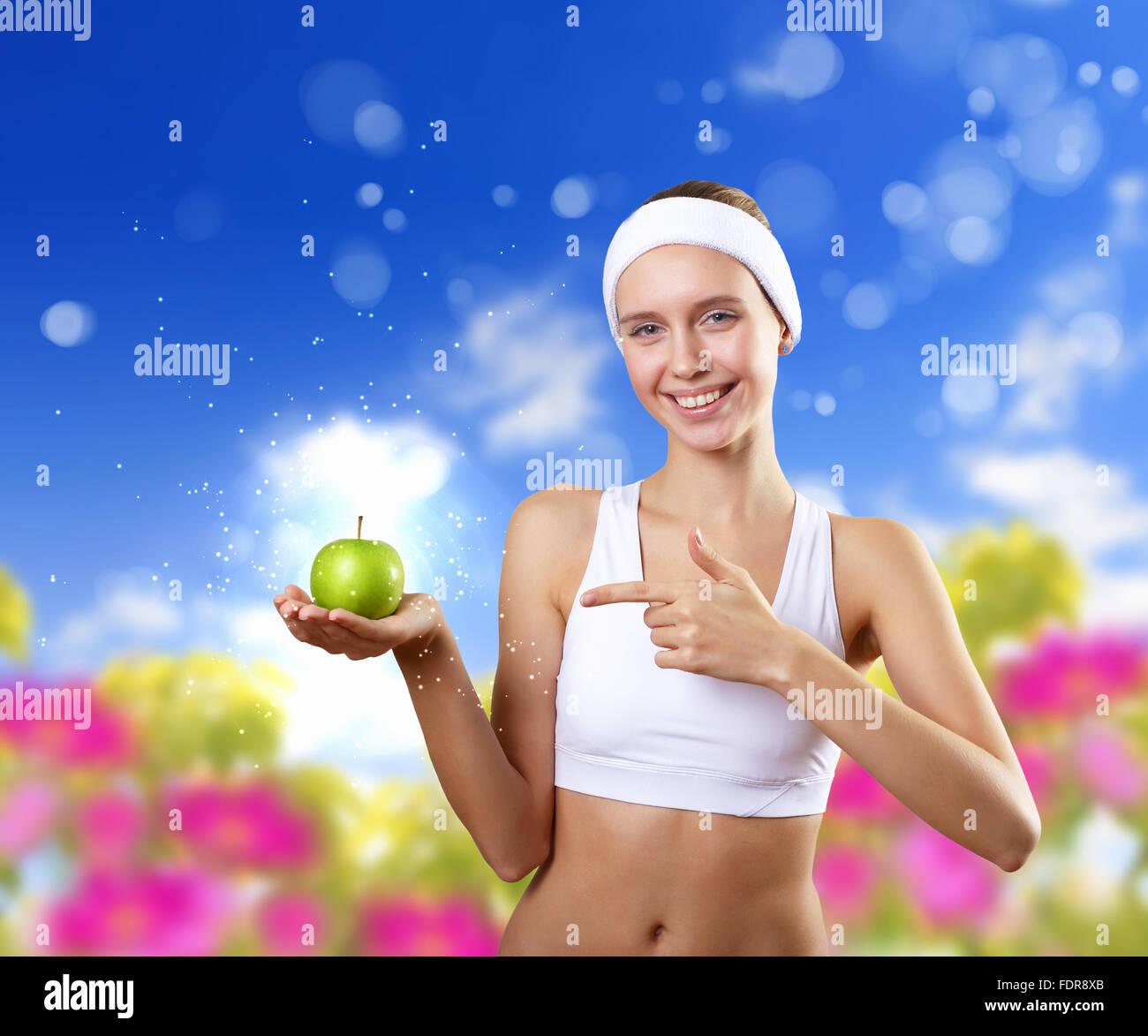 Young pretty girl in sport wear with green apple Stock Photo - Alamy