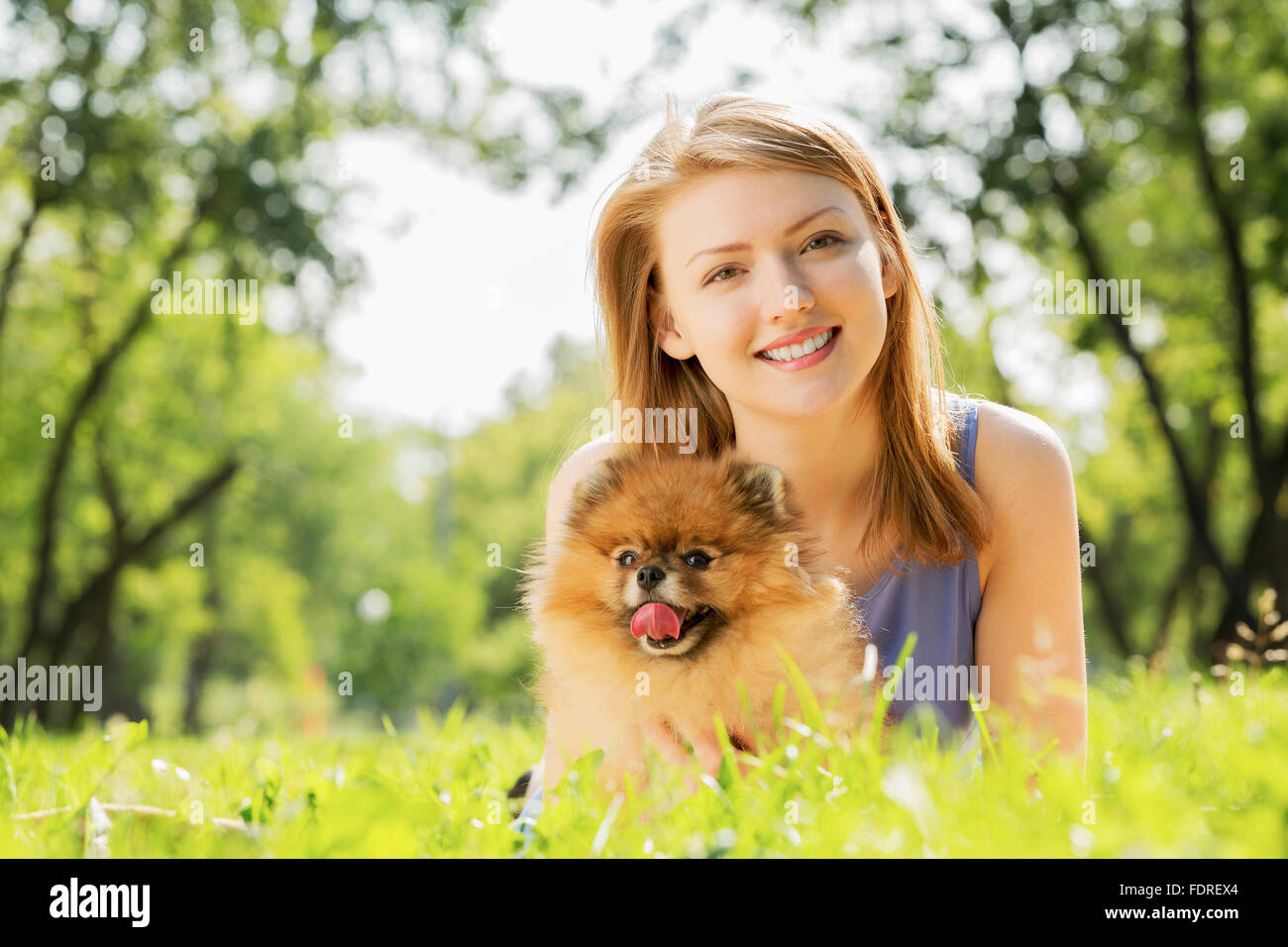 Young pretty girl in summer park with cute dog Stock Photo - Alamy