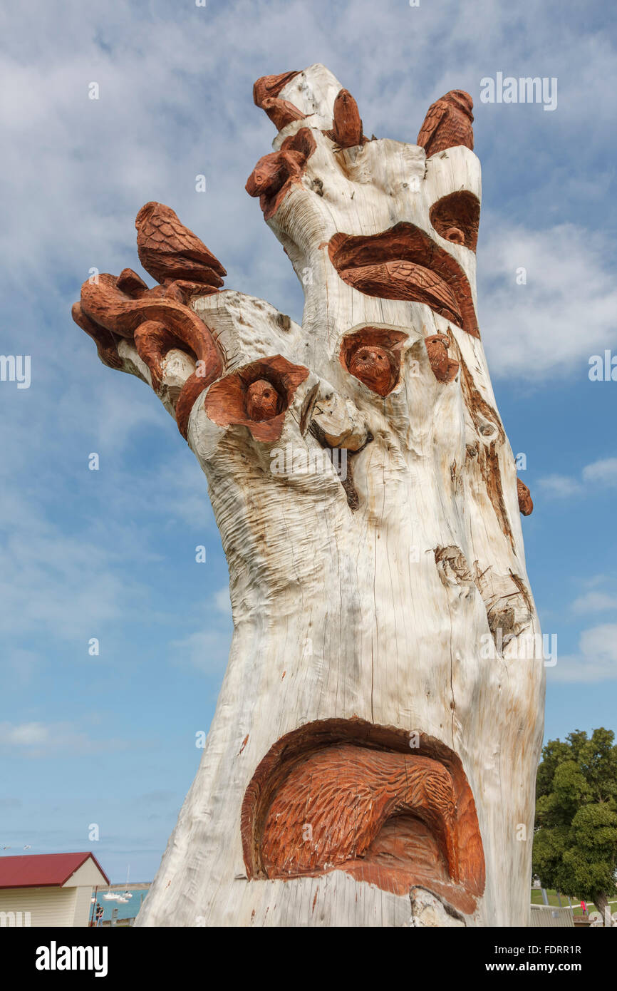 Wood carving on tree in Harbour Tourist Park,Oamaru, North Otago,South Island,New Zealand Stock Photo