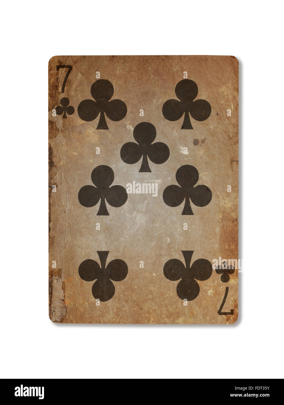 Very old playing card isolated on a white background, seven of clubs Stock Photo