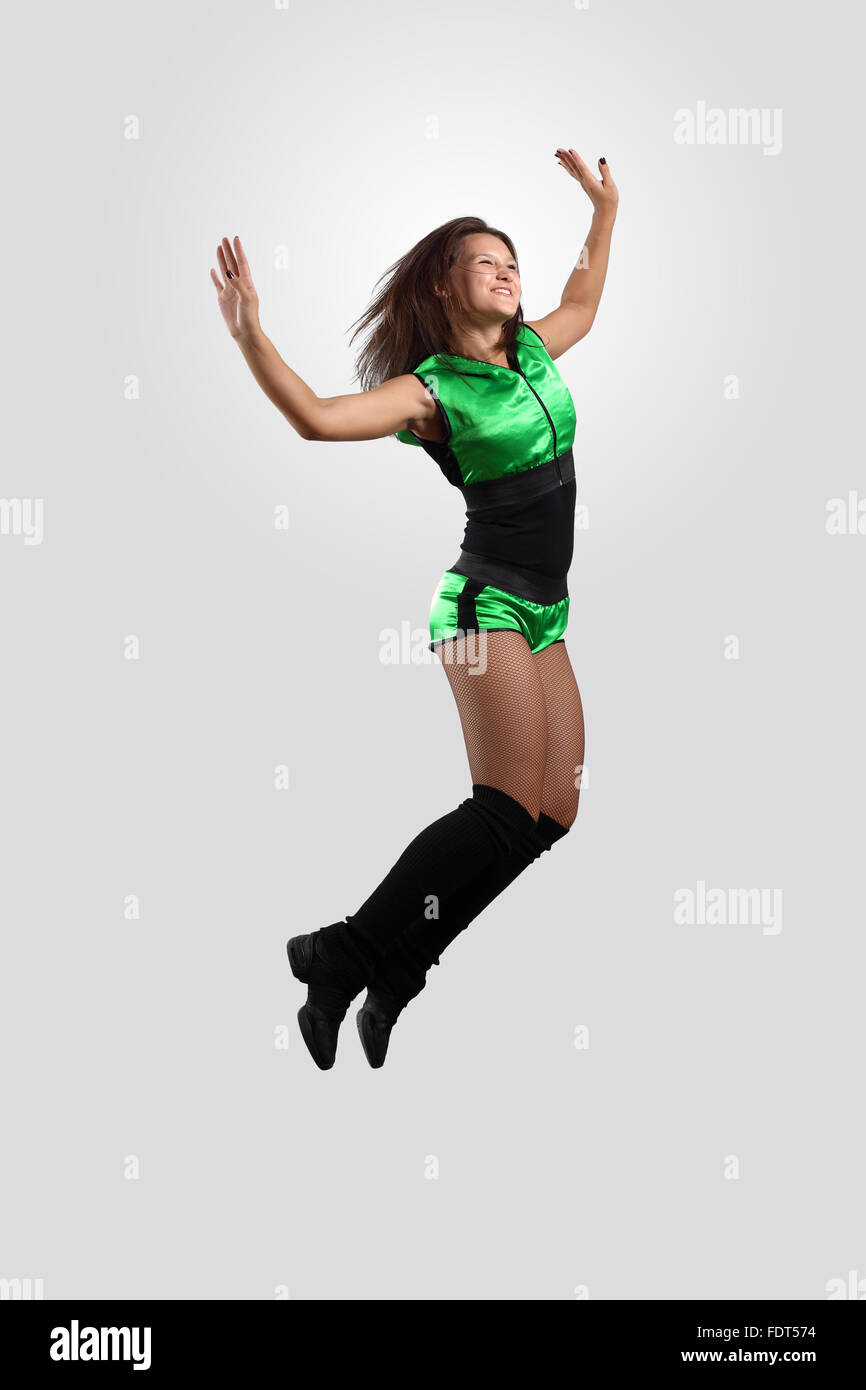 Young female dancer jumping against white background Stock Photo - Alamy