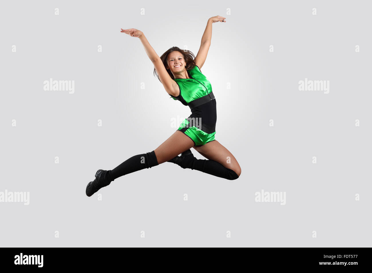 Young female dancer jumping against white background Stock Photo - Alamy