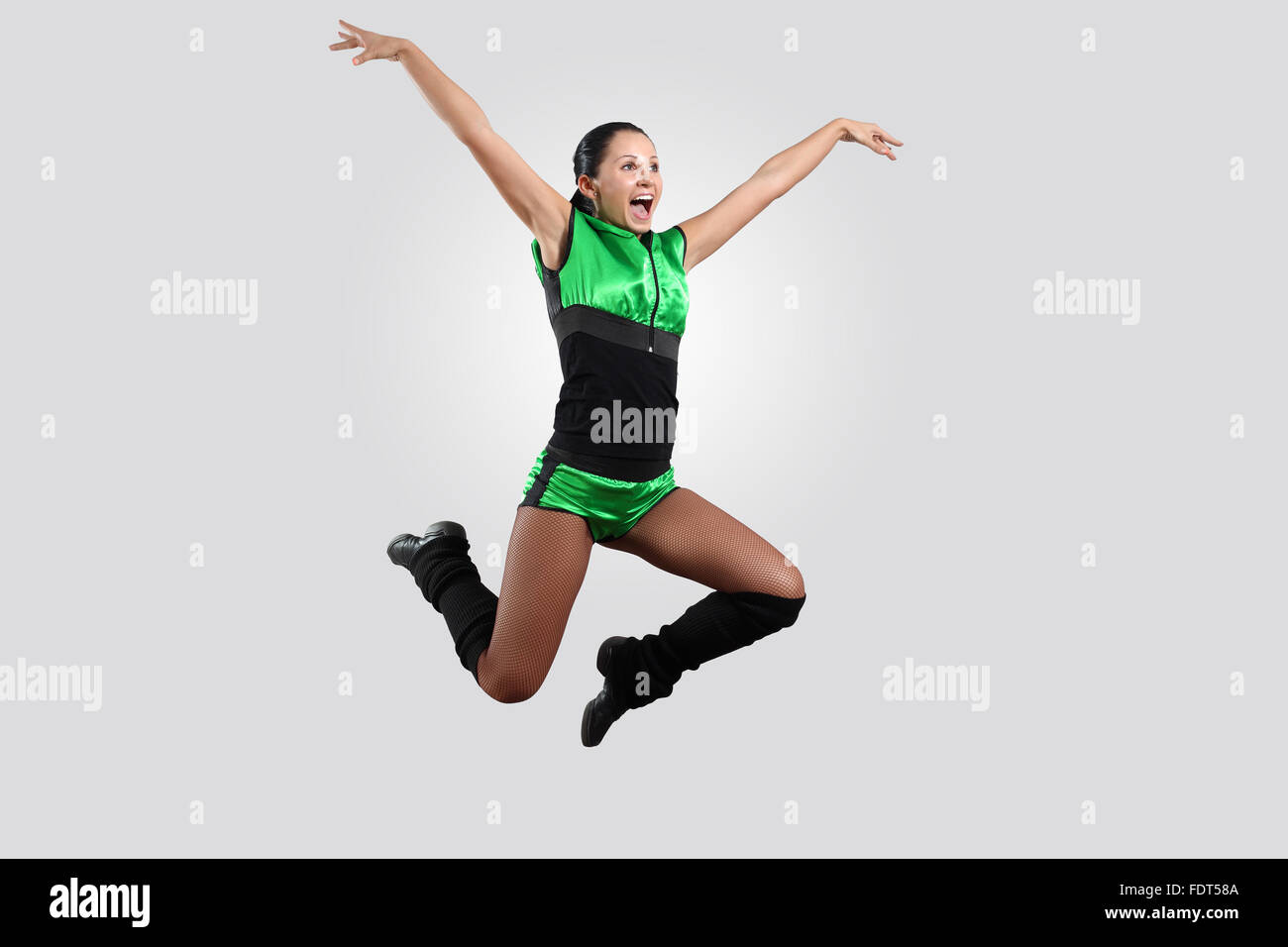 Young female dancer jumping against white background Stock Photo - Alamy