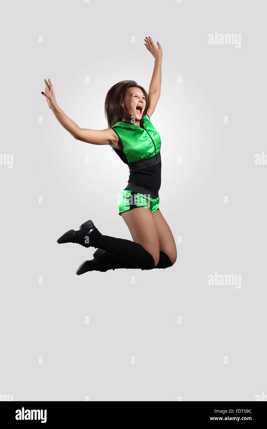 Young female dancer jumping against white background Stock Photo - Alamy