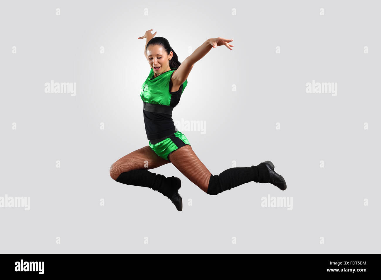 Young female dancer jumping against white background Stock Photo - Alamy