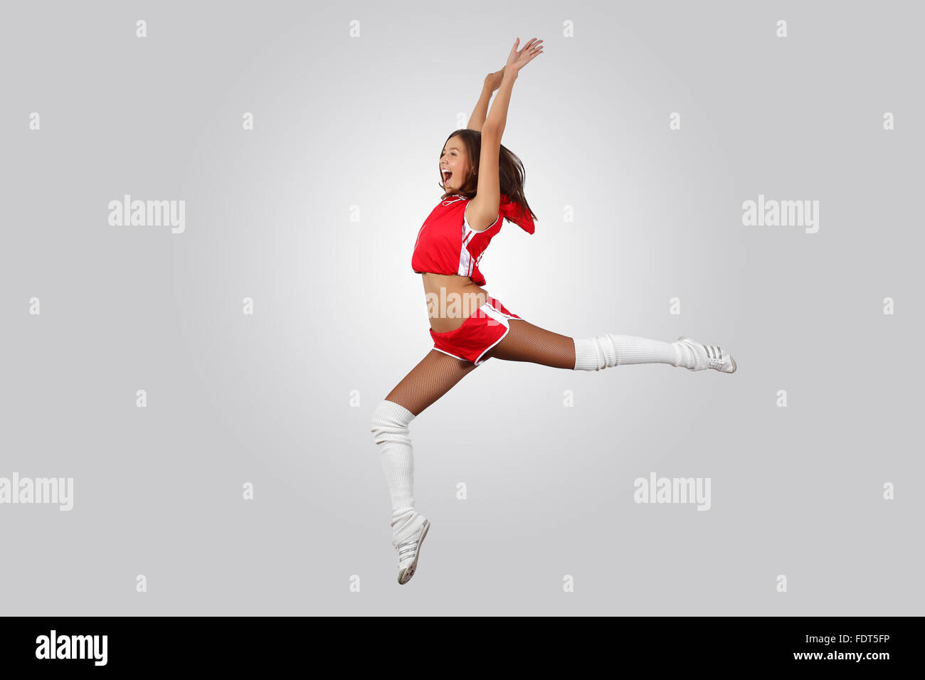 Young female dancer jumping against white background Stock Photo - Alamy