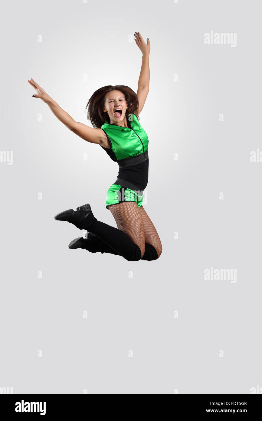 Young female dancer jumping against white background Stock Photo - Alamy